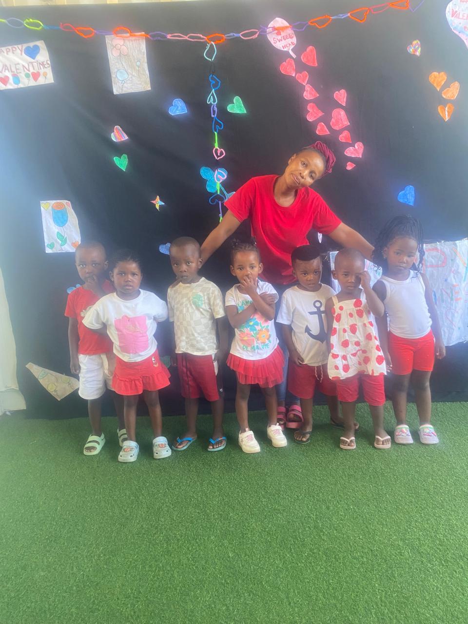 Class photo of our youngest learners with their teacher